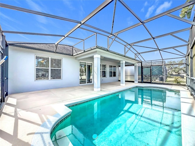 view of swimming pool featuring a patio and glass enclosure