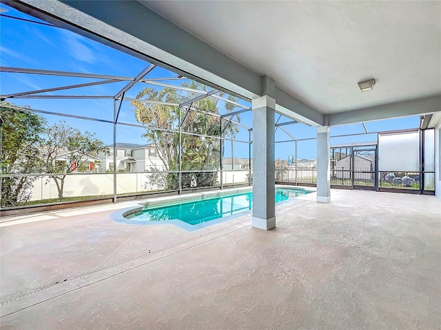 view of swimming pool with a patio and glass enclosure