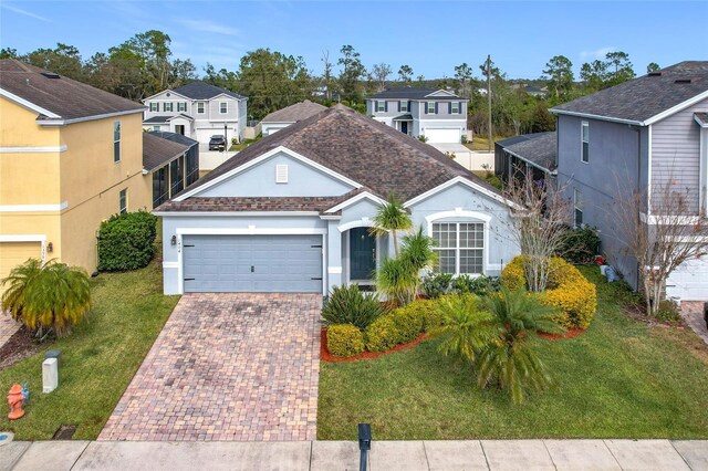 view of front of property with a garage and a front lawn