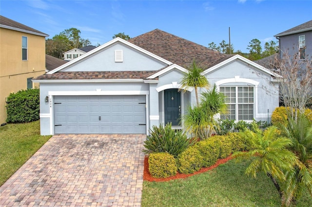 view of front of house featuring a garage and a front lawn