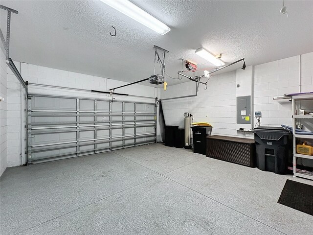 1404 Lexington Ave, Davenport, FL 33837 - garage with a garage door opener, electric panel, and concrete block wall