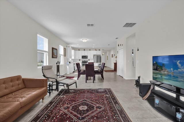 living room with light tile patterned flooring