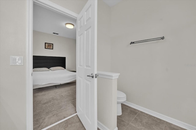 bathroom with tile patterned flooring and toilet