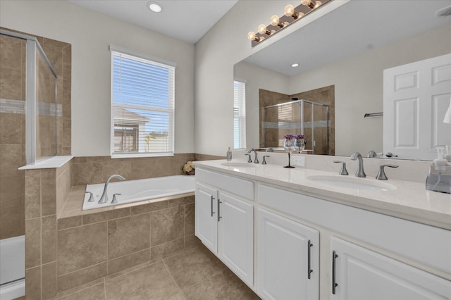 bathroom with tile patterned floors, independent shower and bath, and vanity