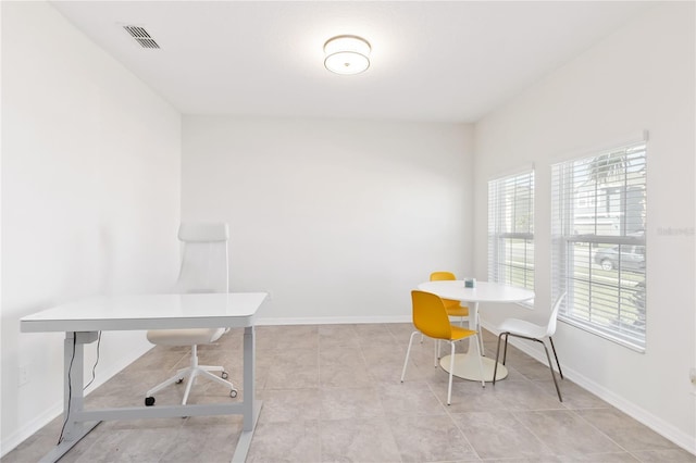 office area with baseboards, visible vents, and light tile patterned floors