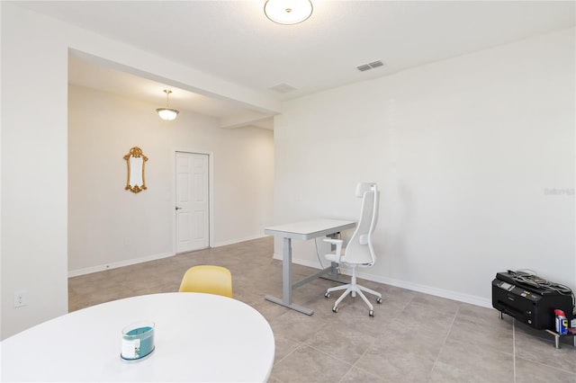 office space with baseboards and visible vents