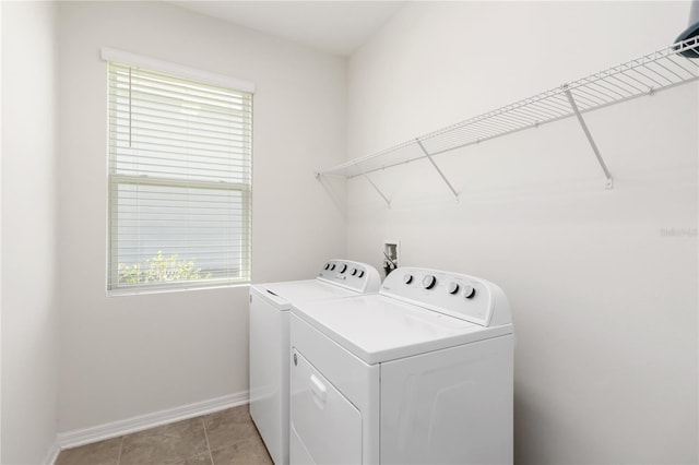 laundry area with baseboards, light tile patterned flooring, laundry area, and washer and clothes dryer