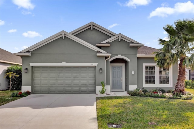 ranch-style home with driveway, an attached garage, a front lawn, roof with shingles, and stucco siding