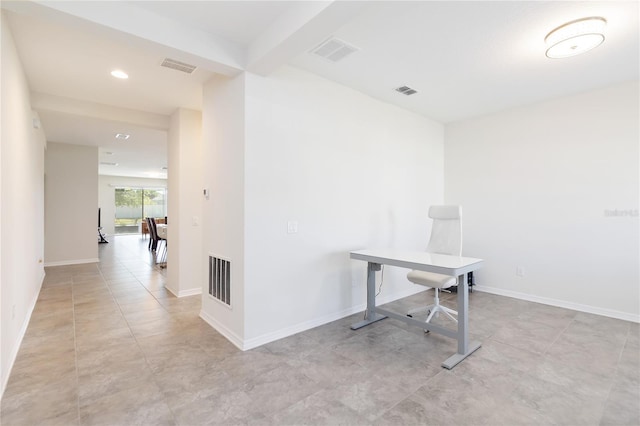 unfurnished office with baseboards and visible vents