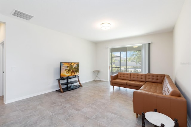 living area with baseboards and visible vents