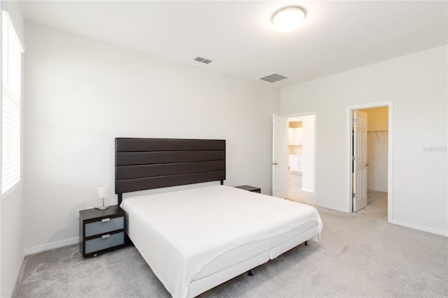 bedroom featuring light carpet, baseboards, and visible vents
