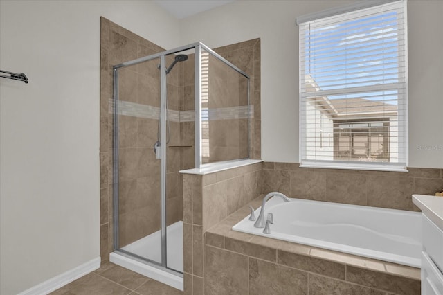 full bath featuring tile patterned floors, a bath, and a shower stall