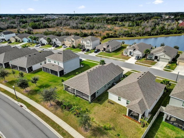 birds eye view of property with a water view and a residential view