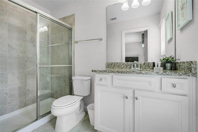 bathroom with walk in shower, vanity, toilet, and tile patterned flooring