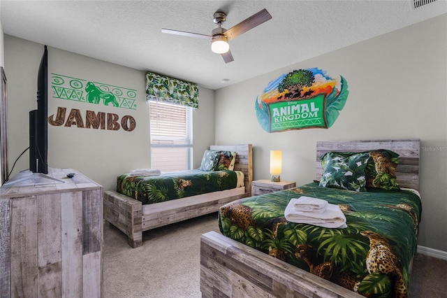 bedroom featuring ceiling fan, carpet floors, and a textured ceiling