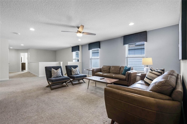 carpeted living room featuring a textured ceiling and ceiling fan