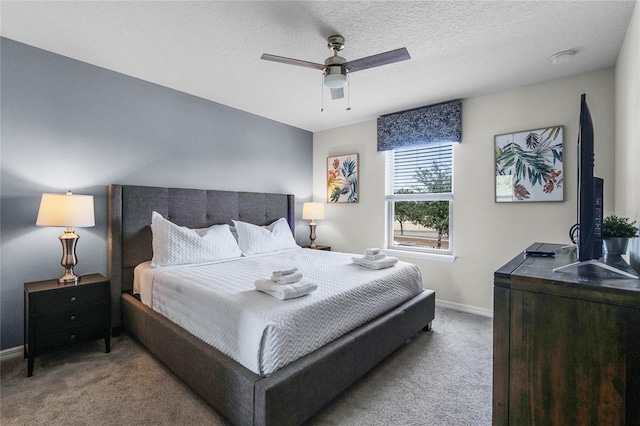 bedroom featuring light carpet, ceiling fan, and a textured ceiling