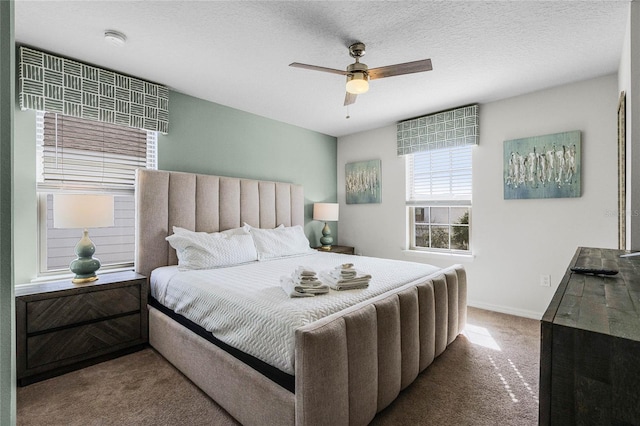 bedroom featuring ceiling fan, a textured ceiling, and carpet flooring