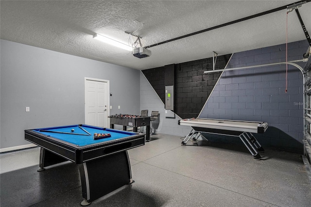 rec room featuring pool table, electric panel, and a textured ceiling