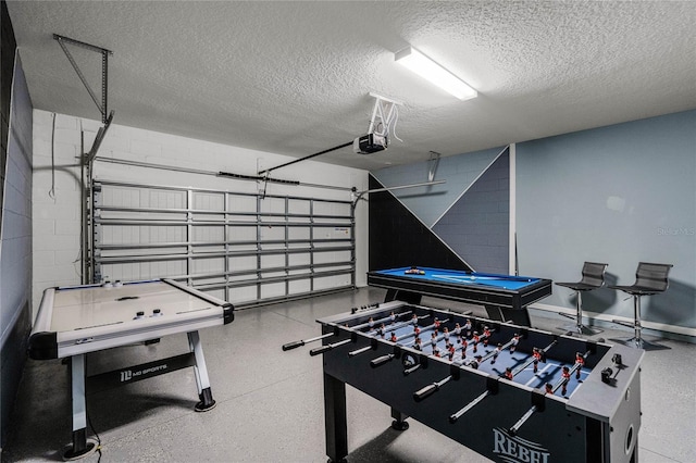 game room featuring a textured ceiling