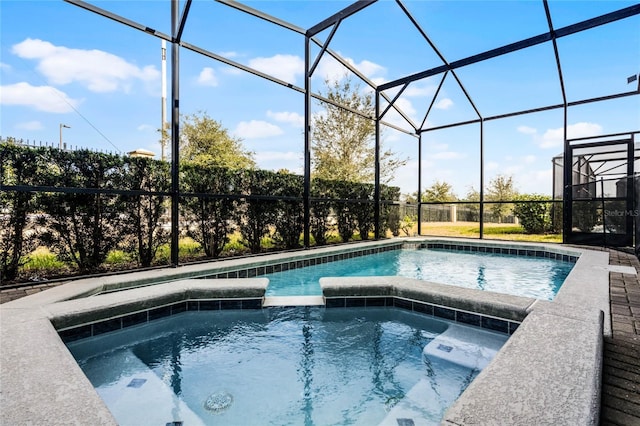 view of swimming pool with an in ground hot tub and glass enclosure