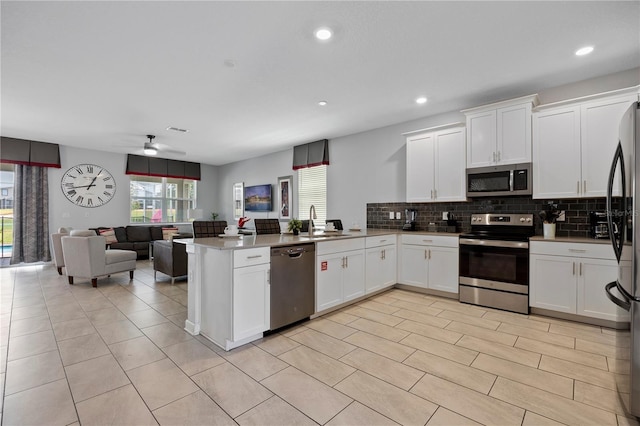 kitchen featuring white cabinetry, stainless steel appliances, and kitchen peninsula