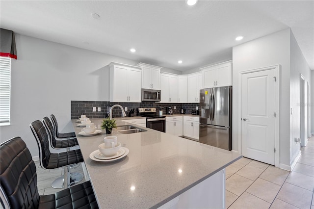 kitchen featuring sink, stainless steel appliances, and white cabinets