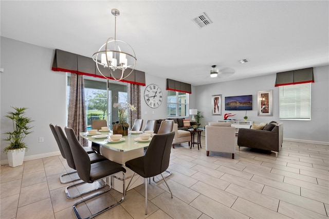 dining room with ceiling fan with notable chandelier