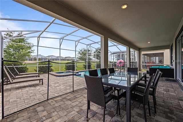 view of patio / terrace with glass enclosure and a pool with hot tub