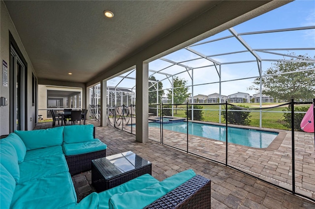 view of pool with an in ground hot tub, an outdoor hangout area, glass enclosure, and a patio