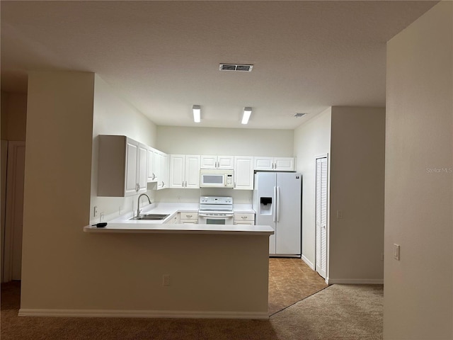 kitchen featuring sink, white cabinetry, light colored carpet, kitchen peninsula, and white appliances