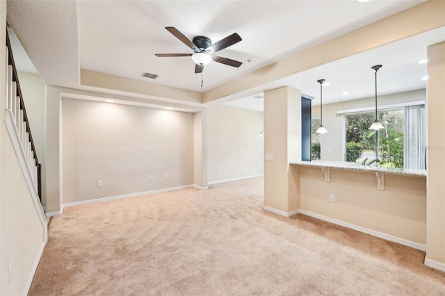 carpeted spare room with ceiling fan