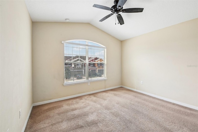 carpeted spare room with ceiling fan and lofted ceiling