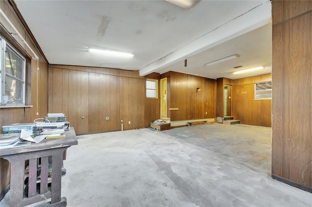 basement featuring wooden walls