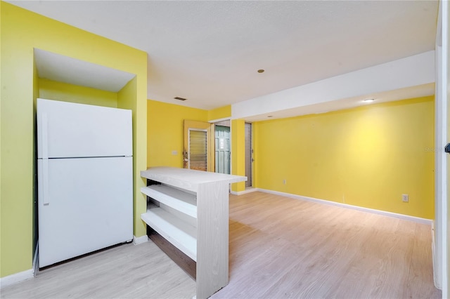 kitchen featuring white refrigerator and light hardwood / wood-style flooring