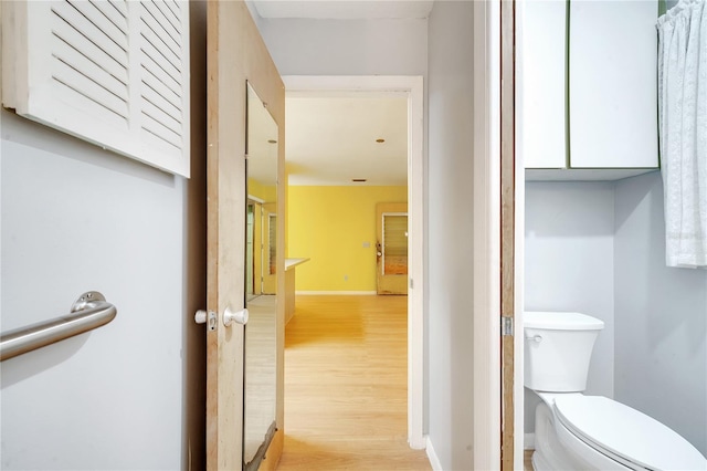 bathroom with wood-type flooring and toilet