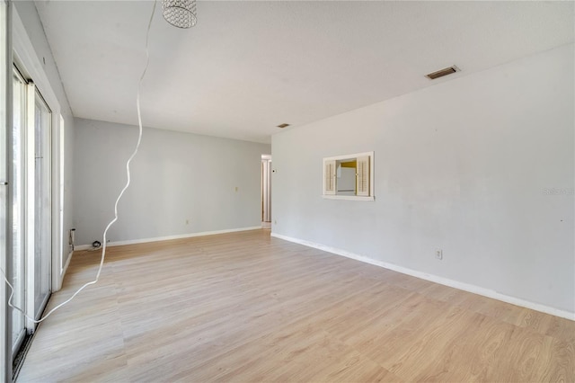 spare room featuring light hardwood / wood-style flooring