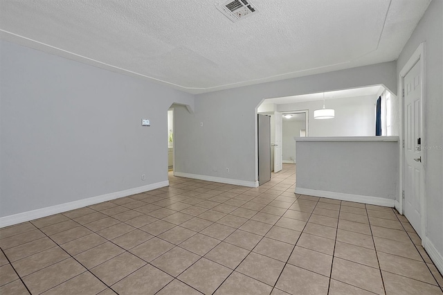 spare room featuring a textured ceiling