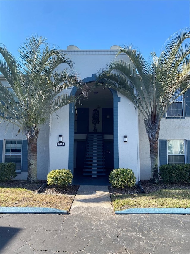 entrance to property featuring stucco siding