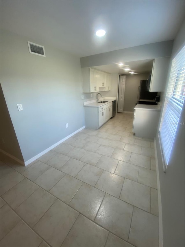 kitchen featuring sink and white cabinets