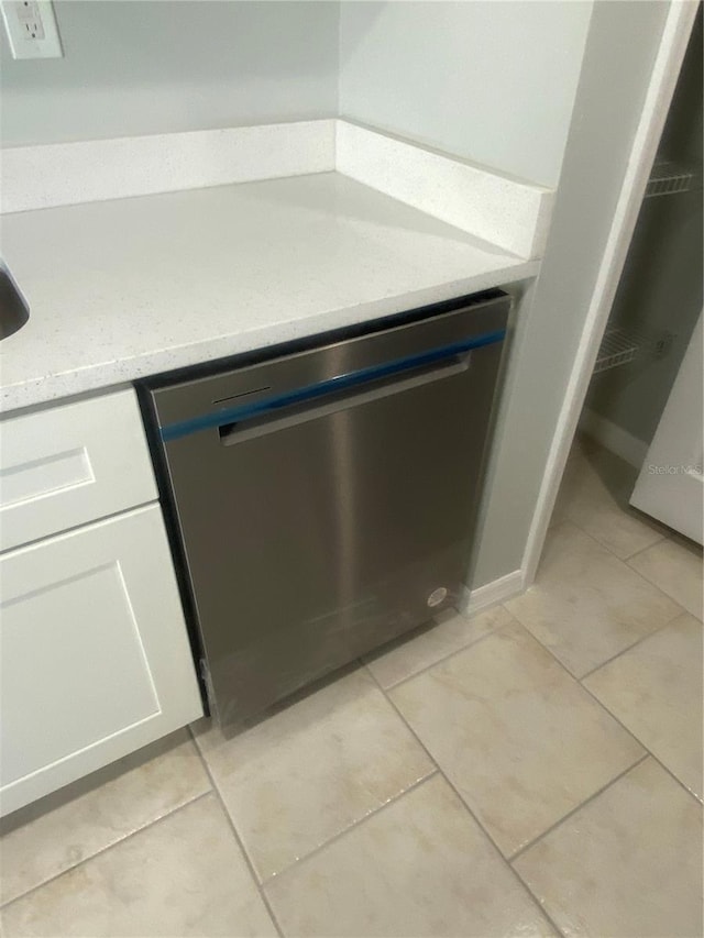 details with white cabinetry, stainless steel dishwasher, and light stone counters