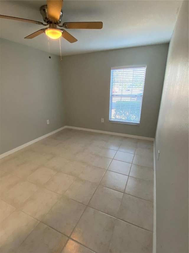 tiled empty room with ceiling fan