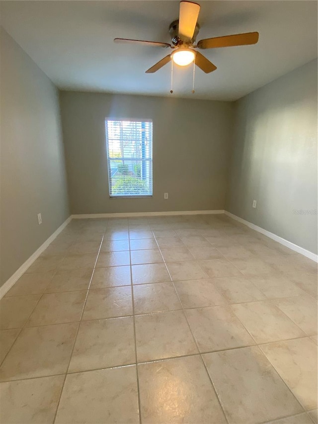 tiled empty room with ceiling fan