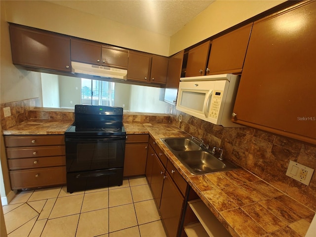 kitchen with sink, tasteful backsplash, a textured ceiling, light tile patterned floors, and black range with electric cooktop