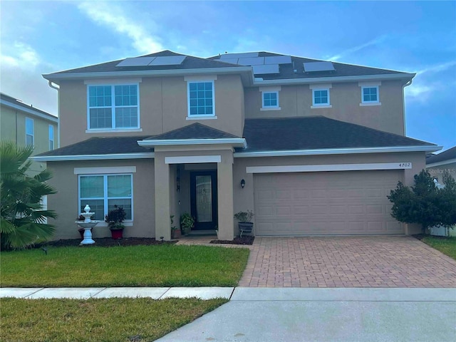 view of front facade with a garage and a front yard