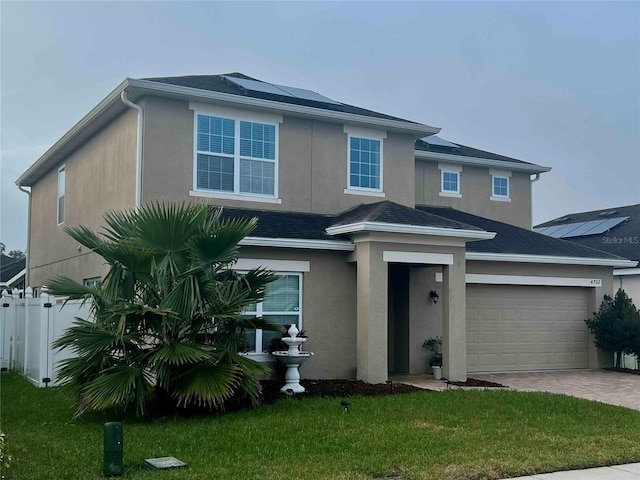 view of front of house with a garage and a front yard