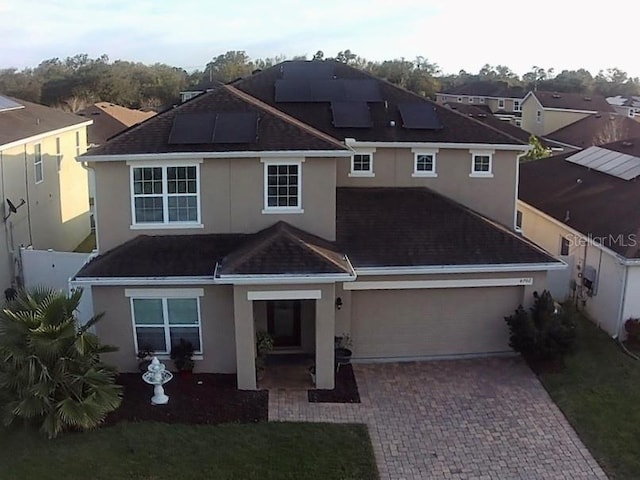 view of front of home with a garage and solar panels