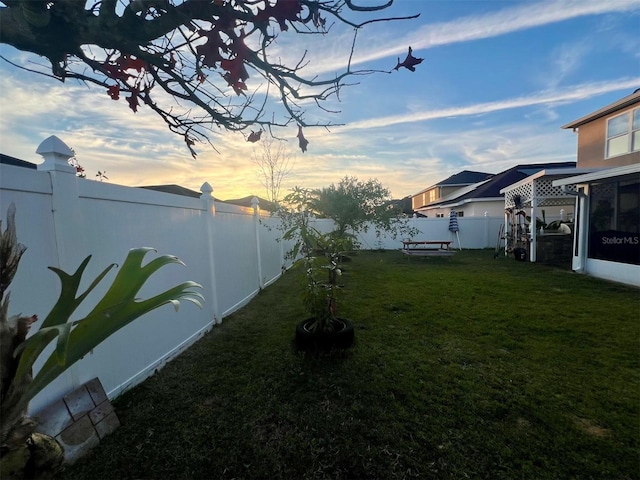 view of yard at dusk