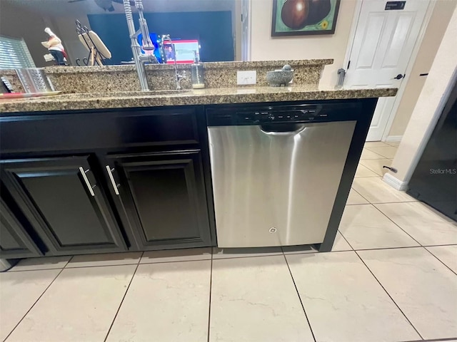 kitchen with dishwasher, light tile patterned floors, and stone counters