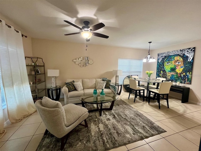 living room featuring light tile patterned flooring and ceiling fan with notable chandelier